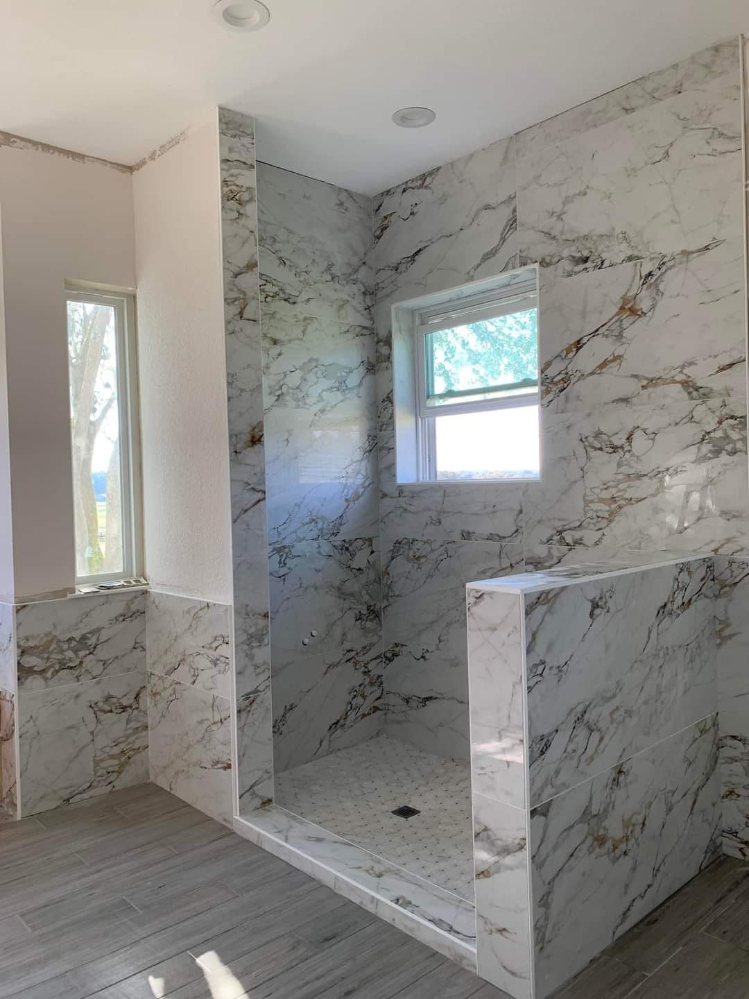 Walk-in shower in book-matched marble tile