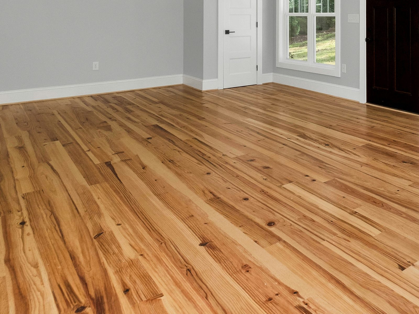 Open living area with newly installed natural hardwood flooring